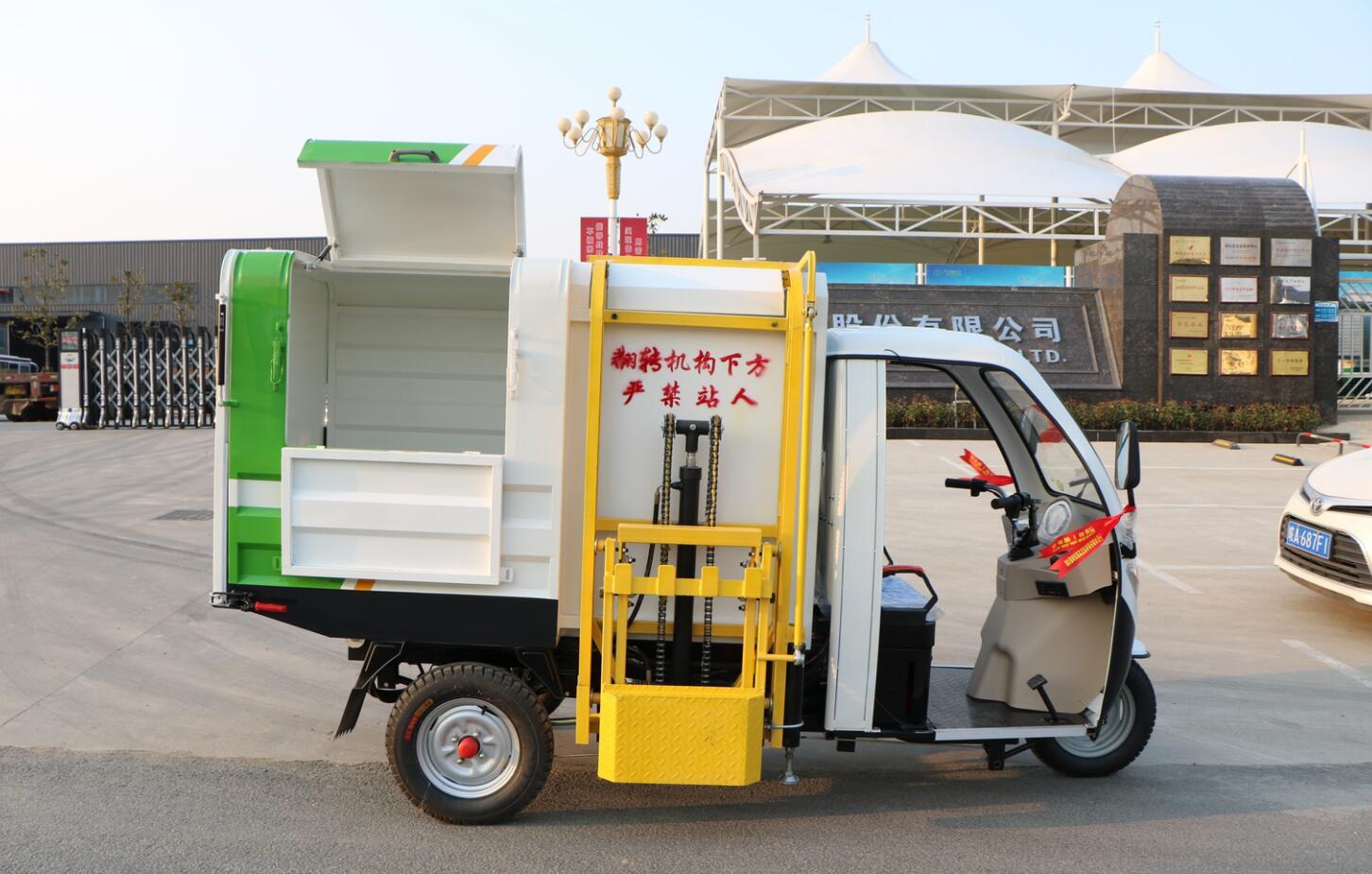 Side tipper electric powered garbage collection and dumping tricycle