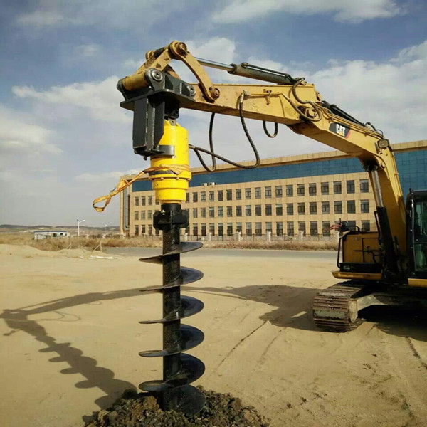 Hydraulic earth auger drive unit mounted on excavator for hole digging or screw piling project