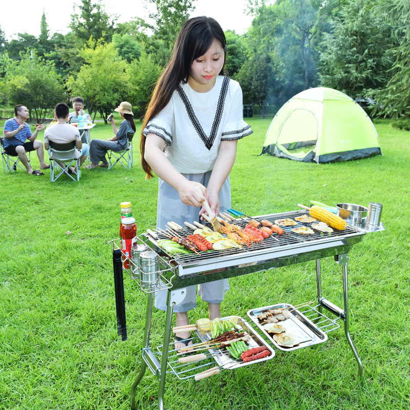 Portable stainless steel BBQ grill with tool and accessory basket