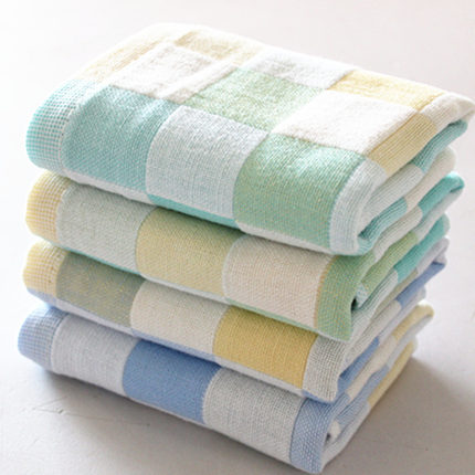 The checkered face towel is made up of 100 bamboo doughnuts in four colors pink yellow blue and green Naturally pro